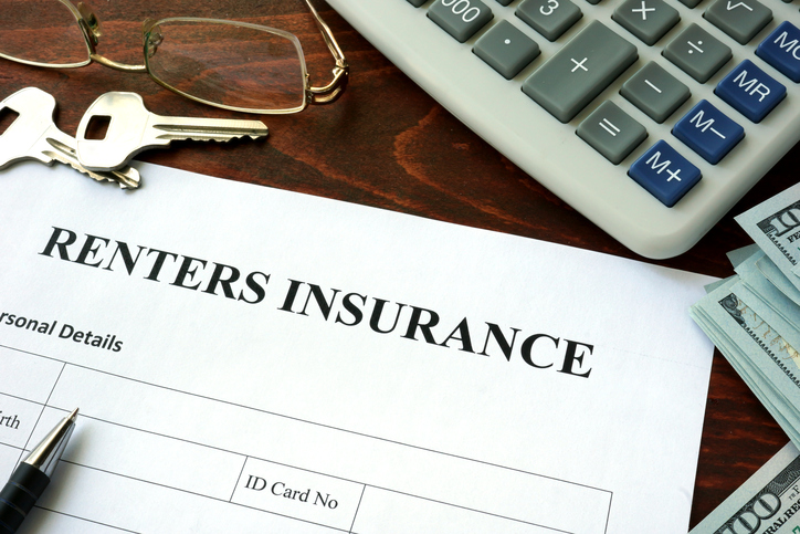 Renters insurance form and dollars on the table.