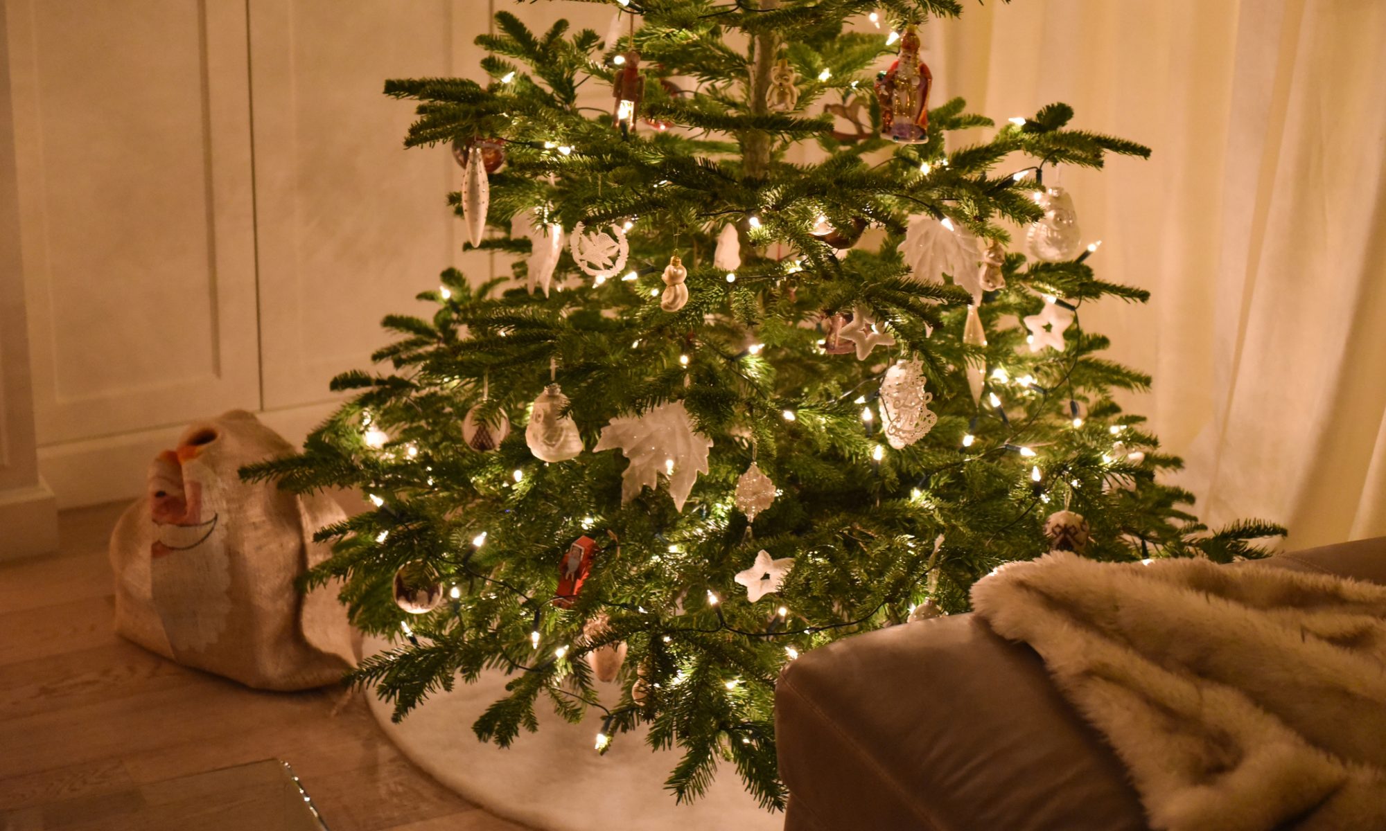 Decorated christmas tree with santa bag under it