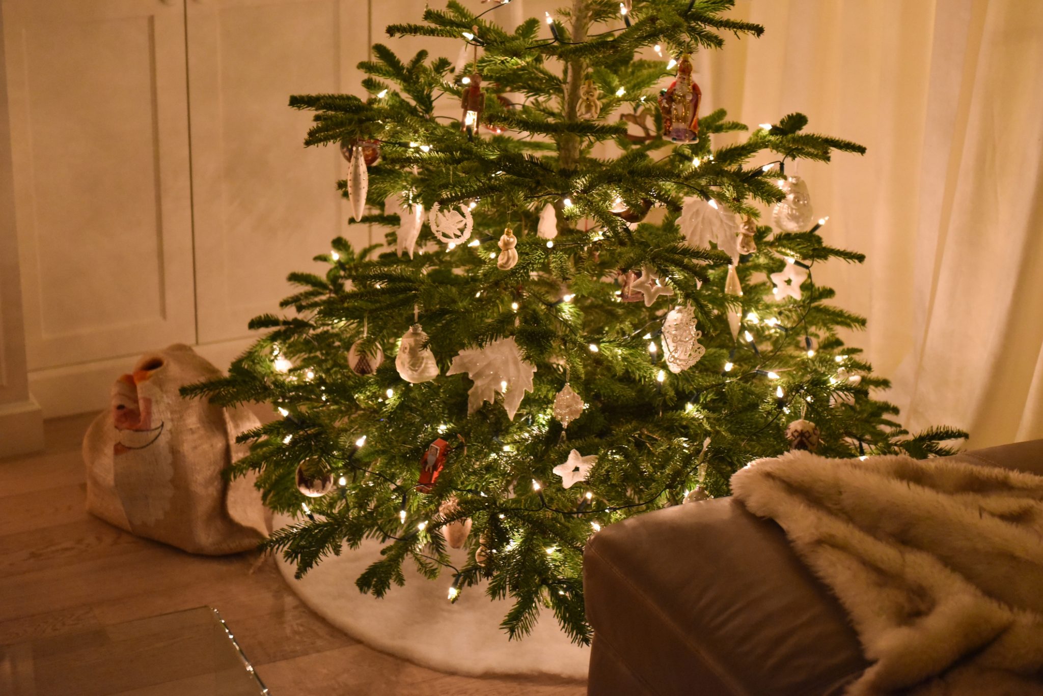 Decorated christmas tree with santa bag under it