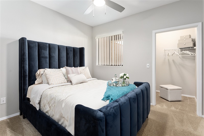 Furnished bedroom shown — representative home at The Cove Apartments.