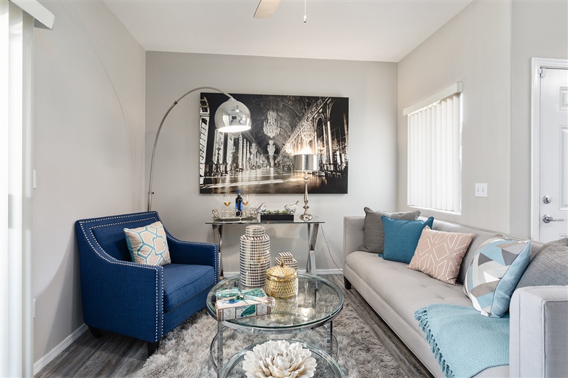 Furnished apartment living area shown — representative home at The Cove Apartments.