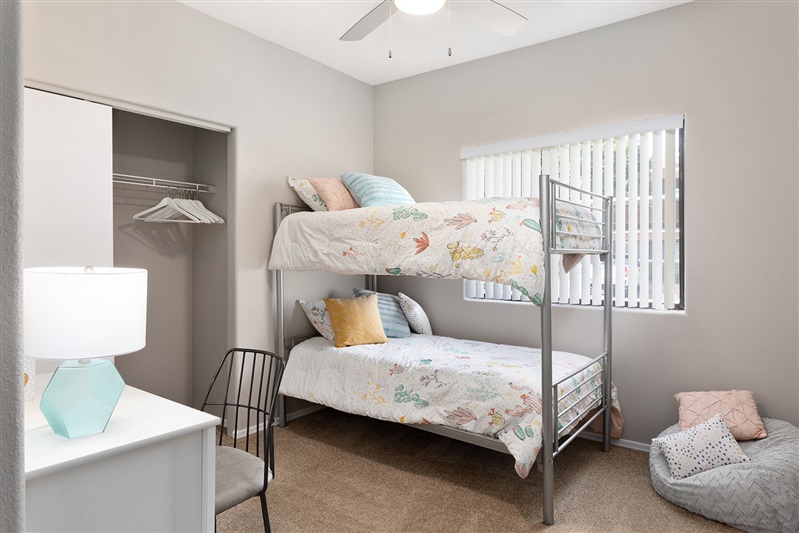 Furnished bedroom shown — representative home at The Cove Apartments.