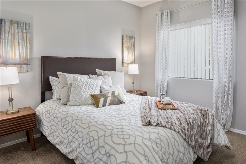 Furnished bedroom shown — representative home at The Cove Apartments.