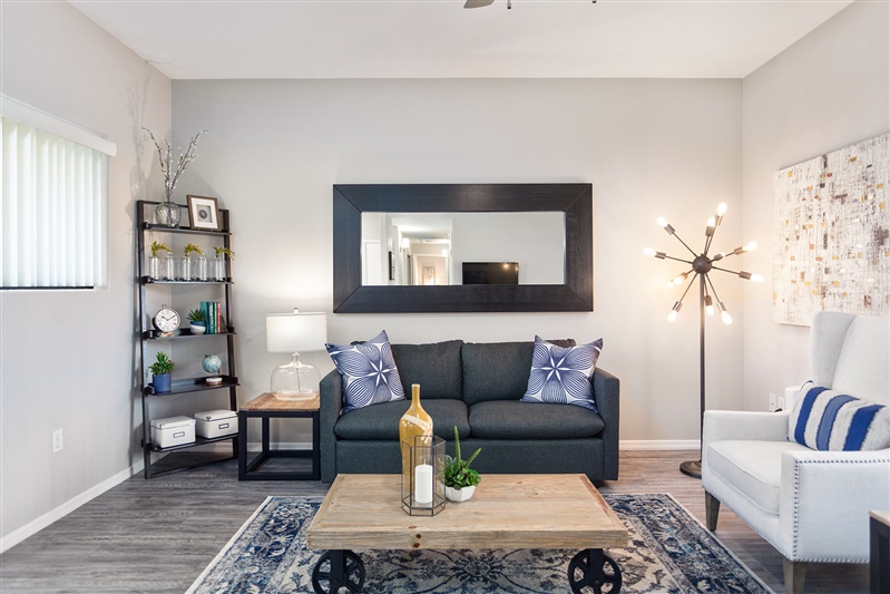 Furnished apartment living area shown — representative home at The Cove Apartments.