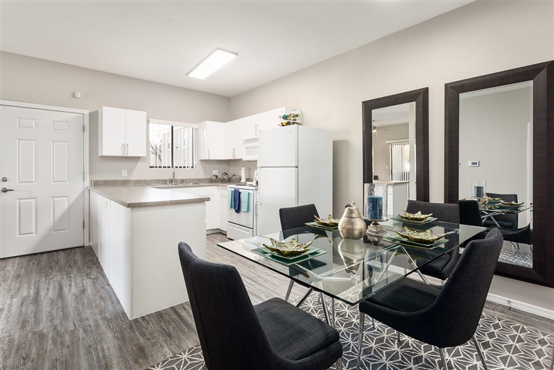 Furnished dining area shown — representative home at The Cove Apartments.